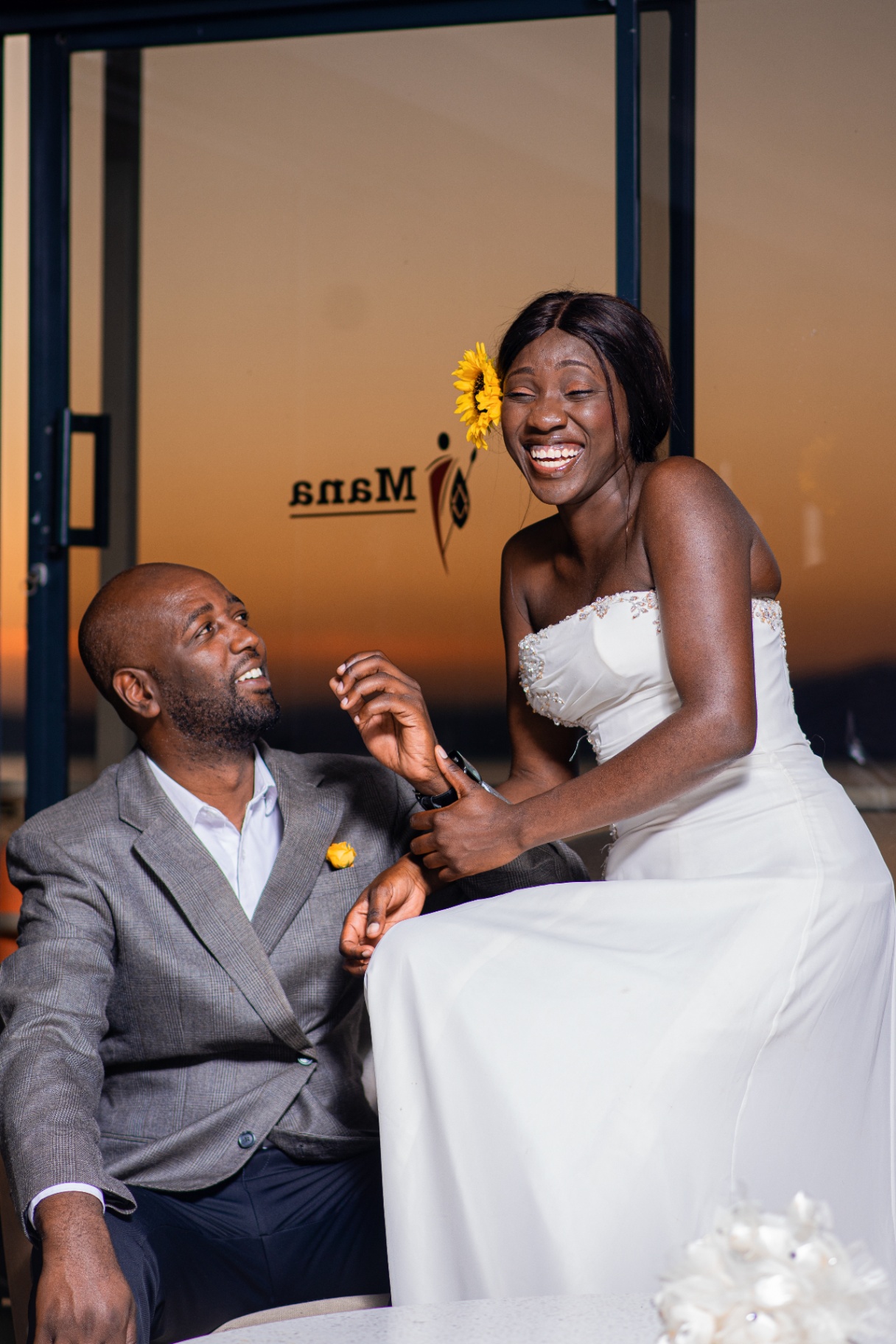 Newlywed couple laughing at golden hour