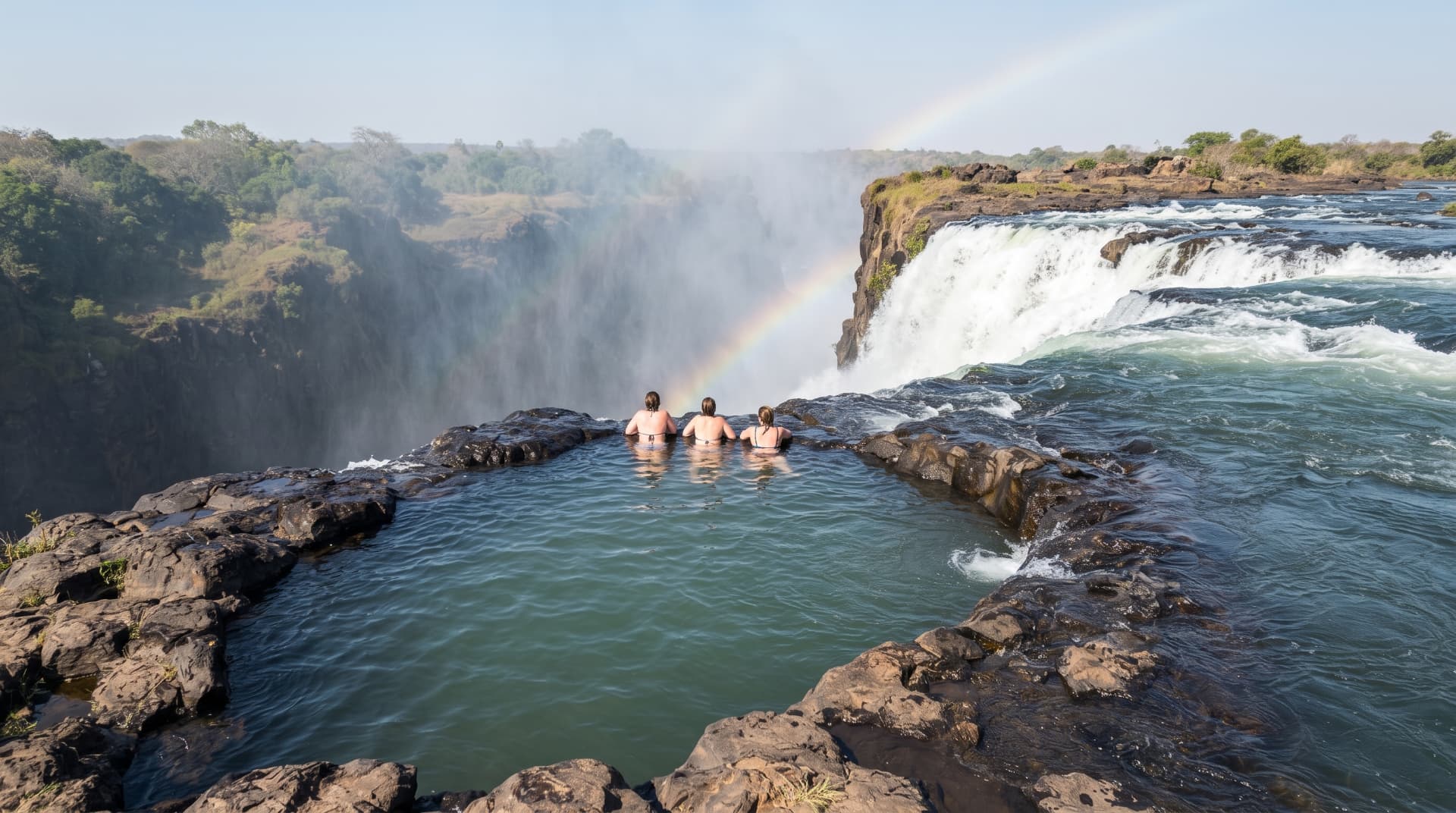 Guests in Devil's Pool at the edge of Victoria Falls